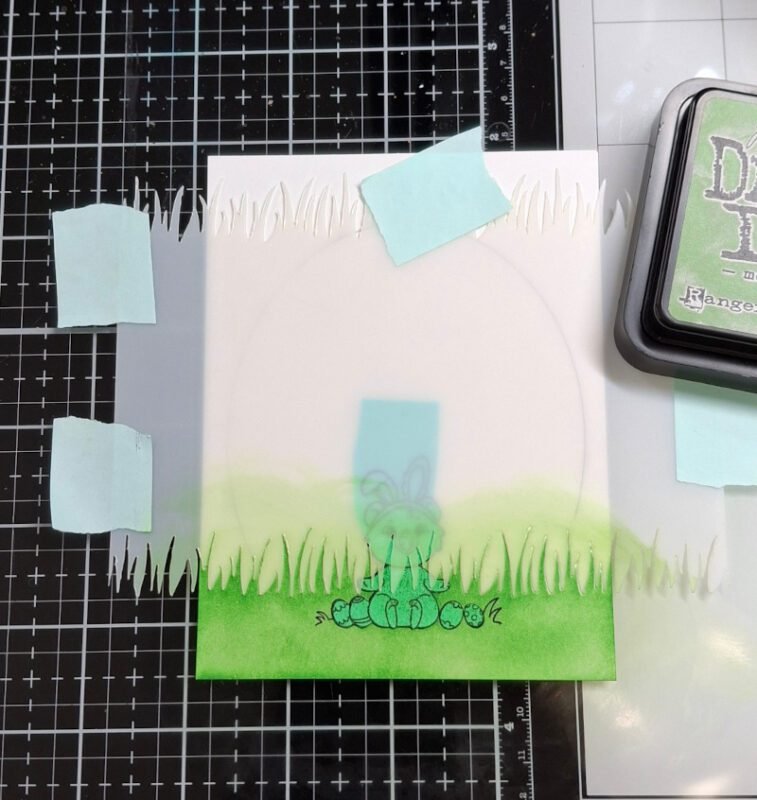 Mask is placed over the quokka and the grass stencil is being used to stencil grass onto the panel